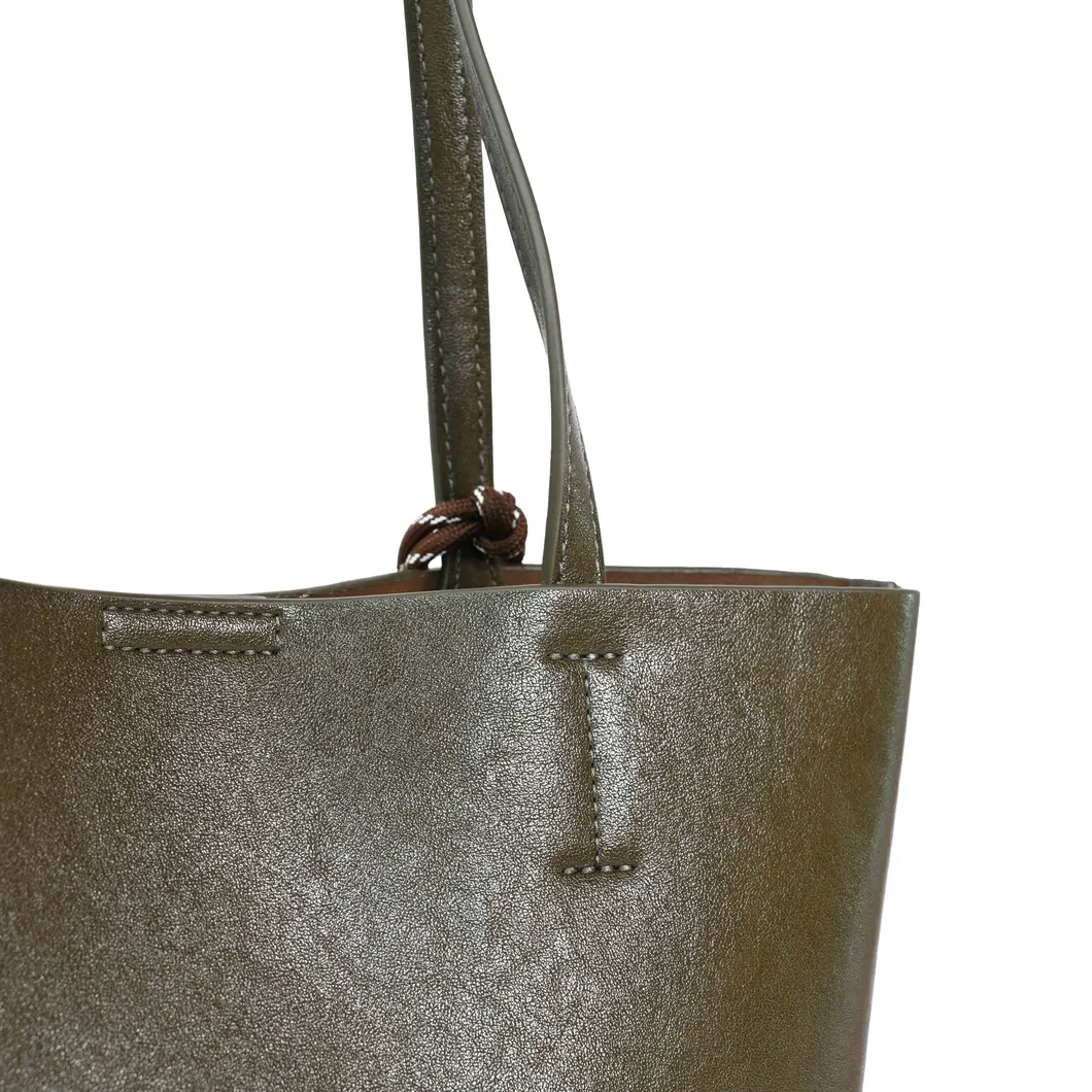 a Brown and Green Spliced Leather Handbag Adorned with Knots