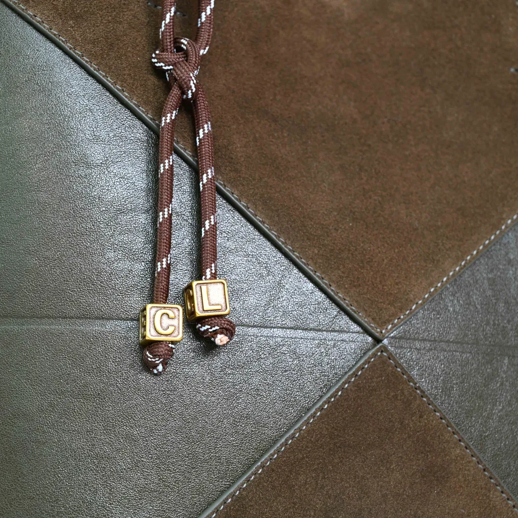a Brown and Green Spliced Leather Handbag Adorned with Knots